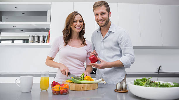 istock Happy couple preparing vegetables together 459965837