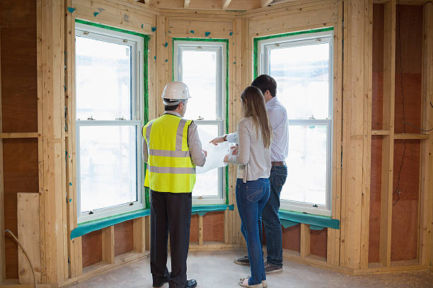 istock Couple and architect standing at the window 459966091