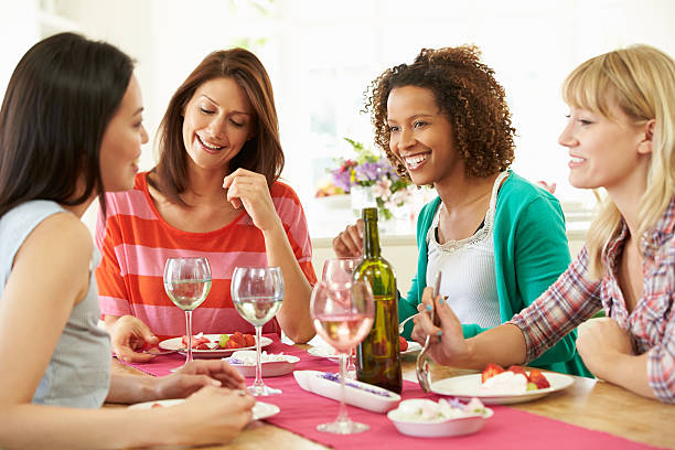istock Group Of Women Sitting Around Table Eating Dessert 459968357