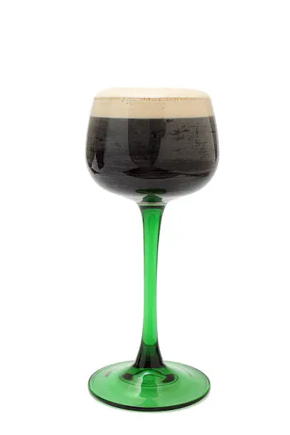 a single long stemmed green glass of guinness - isolated on white - st patricks day symbol