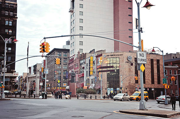 New York, New York, USA - December 21, 2013: Street of Chinatown in New York City, showing pedestrians and traffic.