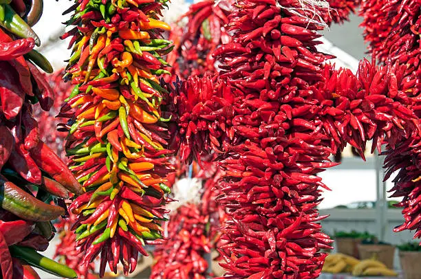 Chili ristras hanging from rack in farmers' market in north central New Mexico