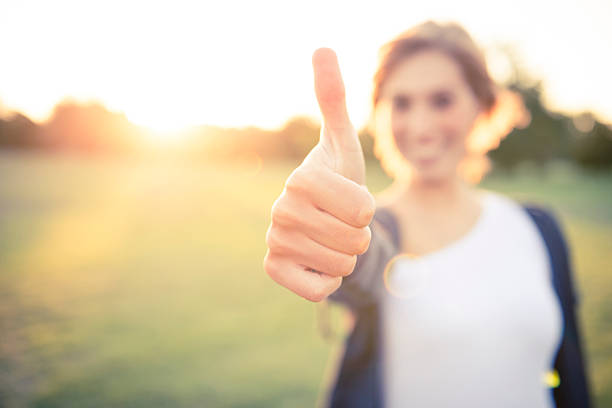 istock Young woman with thumbs up 459971359