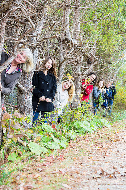 istock Row of people peeking out from behind trees 459972015