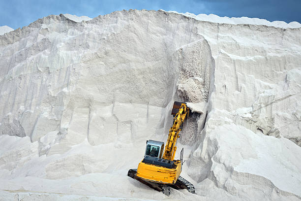 Dangerous digging of sea salt, Puglia, Italy, Europe.
