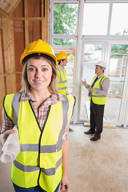 istock Smiling woman holding blueprints 459975279