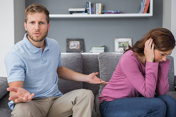 istock Man looking defeated while woman is covering ears 459975321