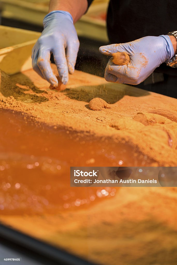 Making Warabi-Mochi Bite-size balls of Japanese warabi mochi, or bracken-starch dumplings, being made from a larger slab of mochi. Bracken Stock Photo