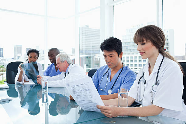 istock Medical team working on files and with an x-ray 459978647