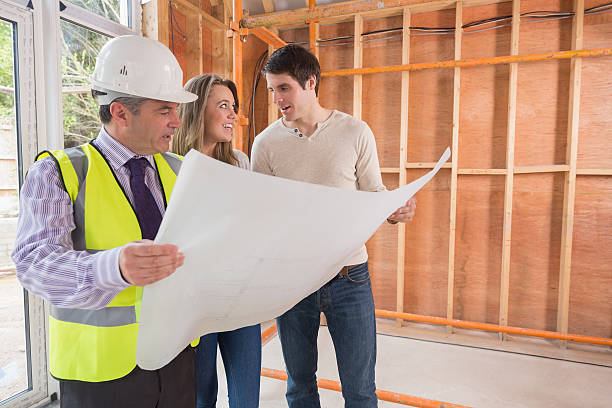istock Couple and architect standing at the house 459978673