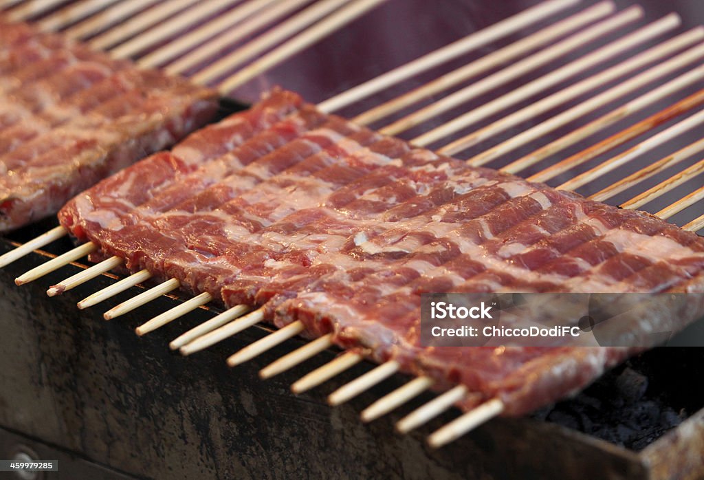 kebabs of lamb roasted on glowing coals many kebabs of lamb roasted on glowing coals during a Festival Baked Stock Photo