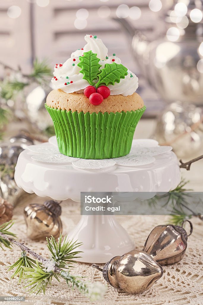Christmas cup cake Christmas cup cake with holly berry Bakery Stock Photo