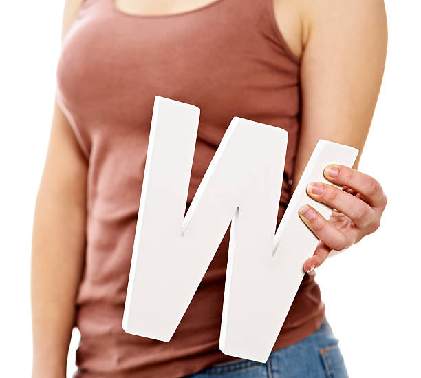 istock Young female hands holding large cut-out letter W 459987955