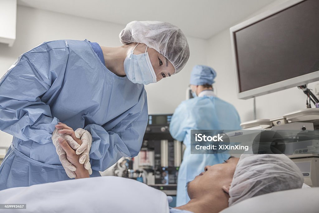 Surgeon consulting a patient, holding hands, getting ready for surgery Patient Stock Photo