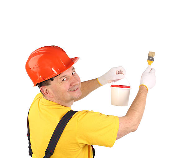 istock Worker in hardhat with paint brush. 459994519