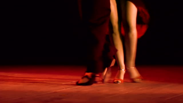 couple feet perform tango