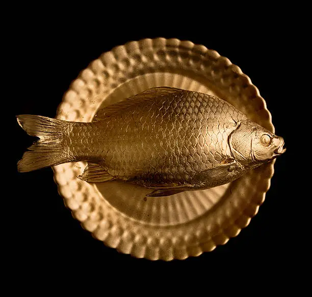 Photo of goldfish on golden plate
