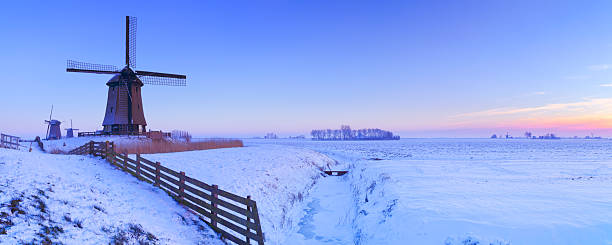 Traditional dutch windmill and reeds on a cold winterday in Groningen.