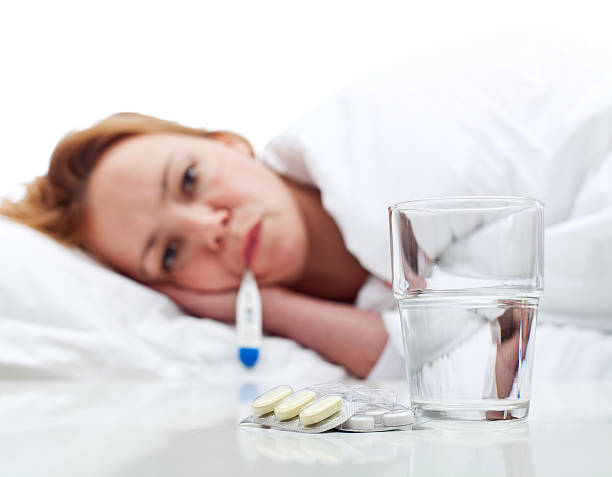 istock Woman got the flu - checking her temperature 460049929