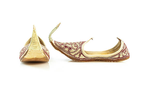 Handmade leather slippers 2 Red handmade slippers from Dubai, isolated on white. handmade indian shoes on white stock pictures, royalty-free photos & images