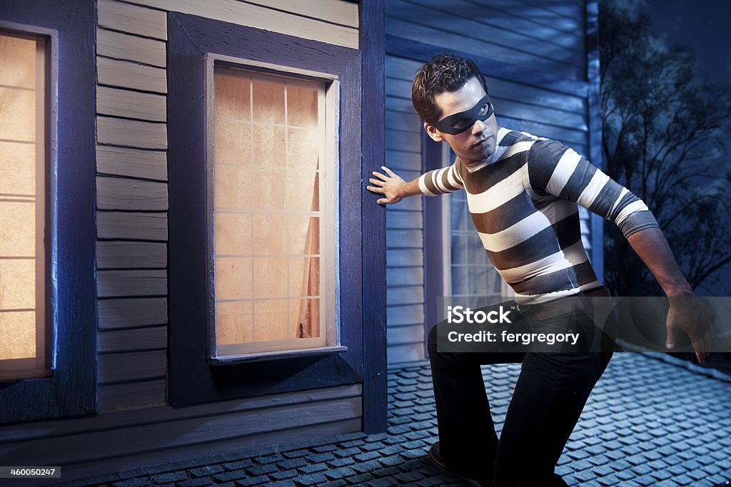 Burglar on the roof of a house House burglar on the roof Adult Stock Photo