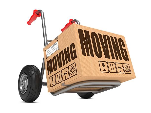 Moving - Cardboard Box on Hand Truck. stock photo