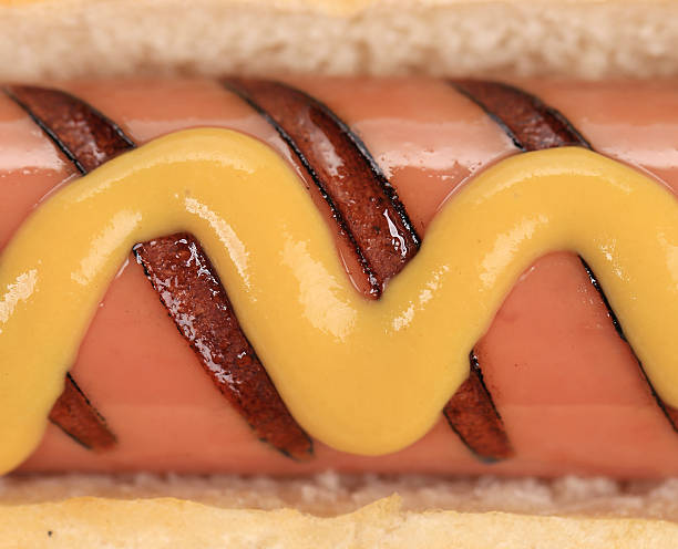 istock Close up of hotdog with mustard. 460054933