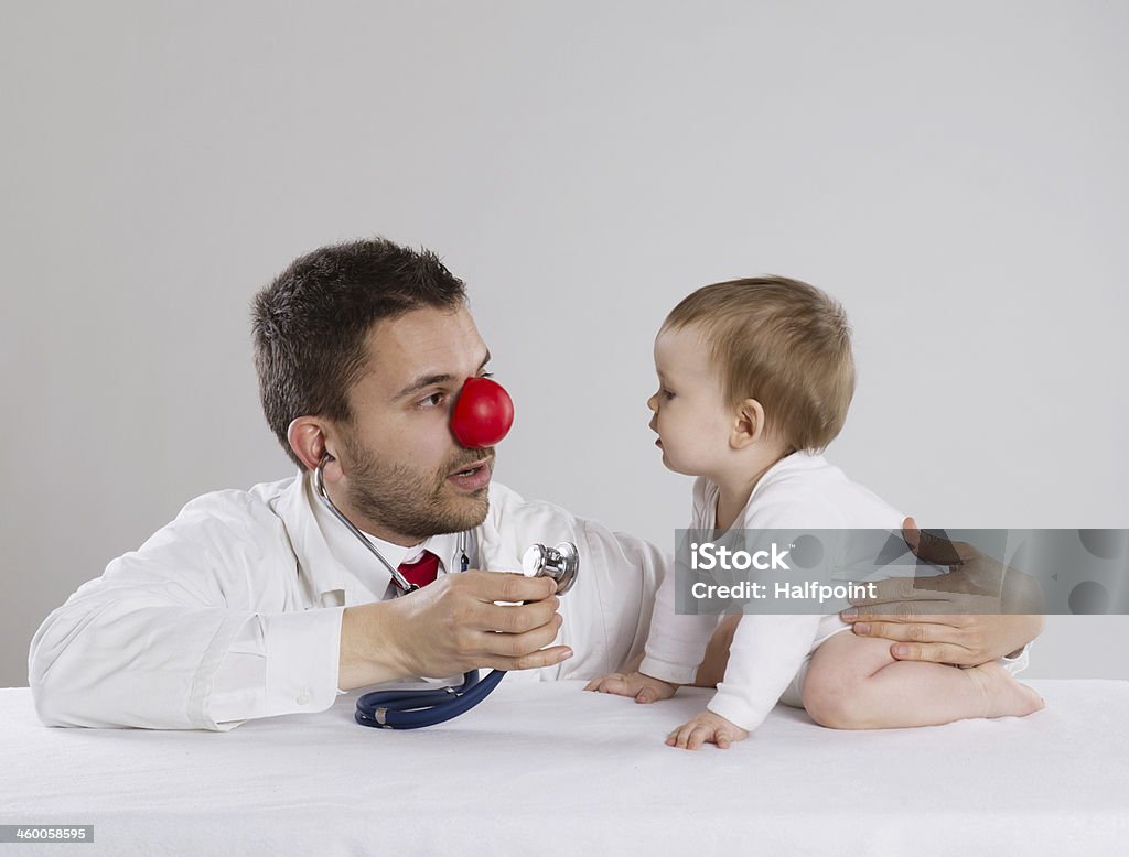 Doctor and child Pediatrician doctor with red nose showing baby stethoscope Adult Stock Photo