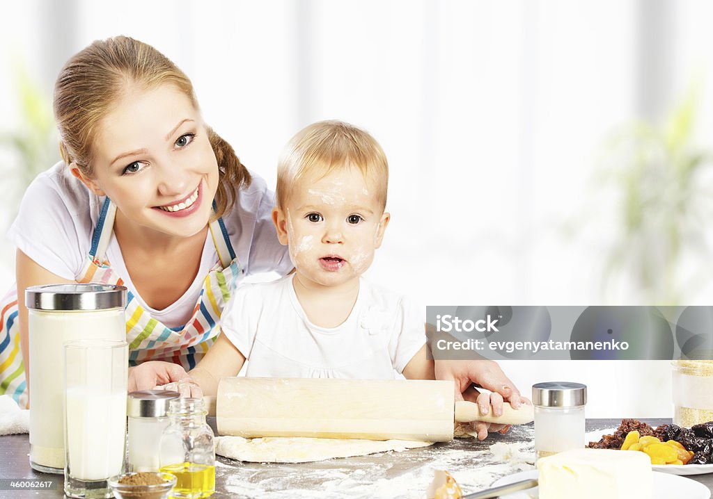 baby girl with her mother cook, bake baby girl with her mother rolled out the dough cook, bake Adult Stock Photo