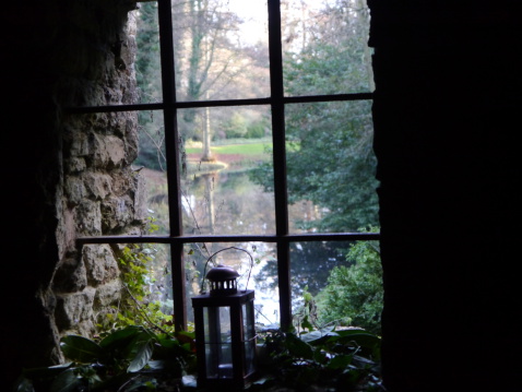 The view from a stone window over a lake on a fresh winters day