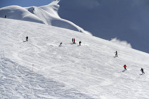 istock Skiers going down the slope at ski resort 460064923
