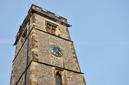 Low angle view of the Clock Tower at St.Albans in Hertfordshire, UK, against a clear blue sky.