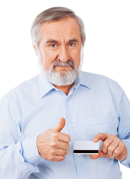 istock Old man holding up a cash card 460070063