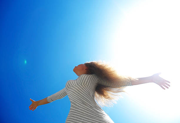 istock Beautiful female over blue clean sky 460071377