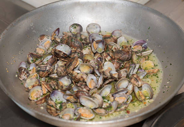 istock Mussels cooking in pan with sauces 460081179