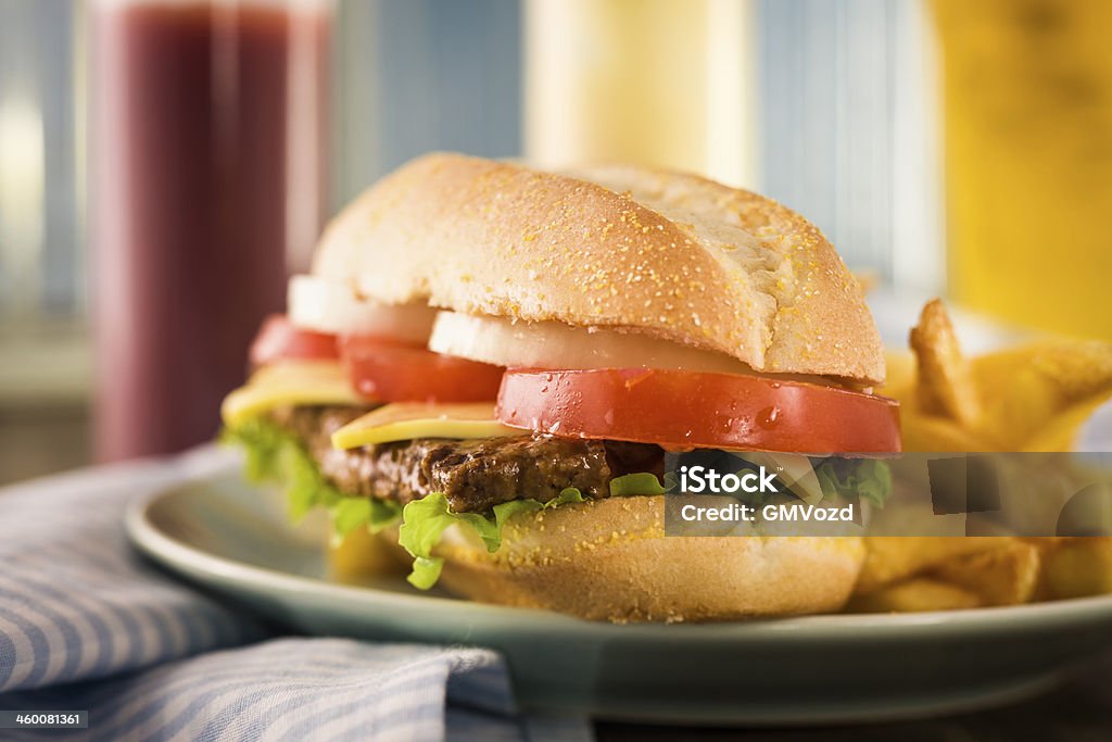 Sparerib Burger Sparerib Burger with cheese, tomatoes,onions and french fries American Culture Stock Photo