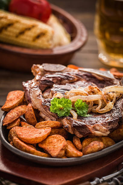istock T-Bone Steak With Potato Wedges 460095951