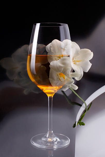 istock Double exposure of glass wine over white freesia 460103403