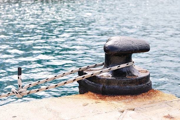 istock Marine rope on mooring bollard in port 460131995