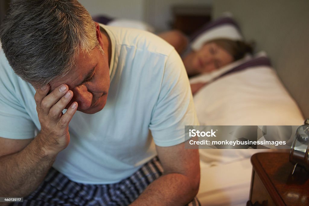 Man Awake In Bed Suffering With Insomnia Man Awake In Bed Suffering With Insomnia Late At Night Insomnia Stock Photo