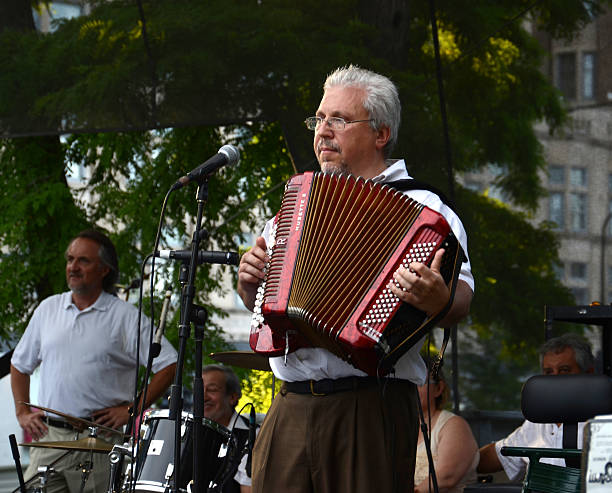 Peter Sadkhin at SummerDance Chicago 2013 Chicago, United States - July 18, 2013: Peter Sadkhin, accordionist and band leader of Tum Balalaika Klezmer band, plays at SummerDance in Grant Park on July 28, 2013. klezmer stock pictures, royalty-free photos & images