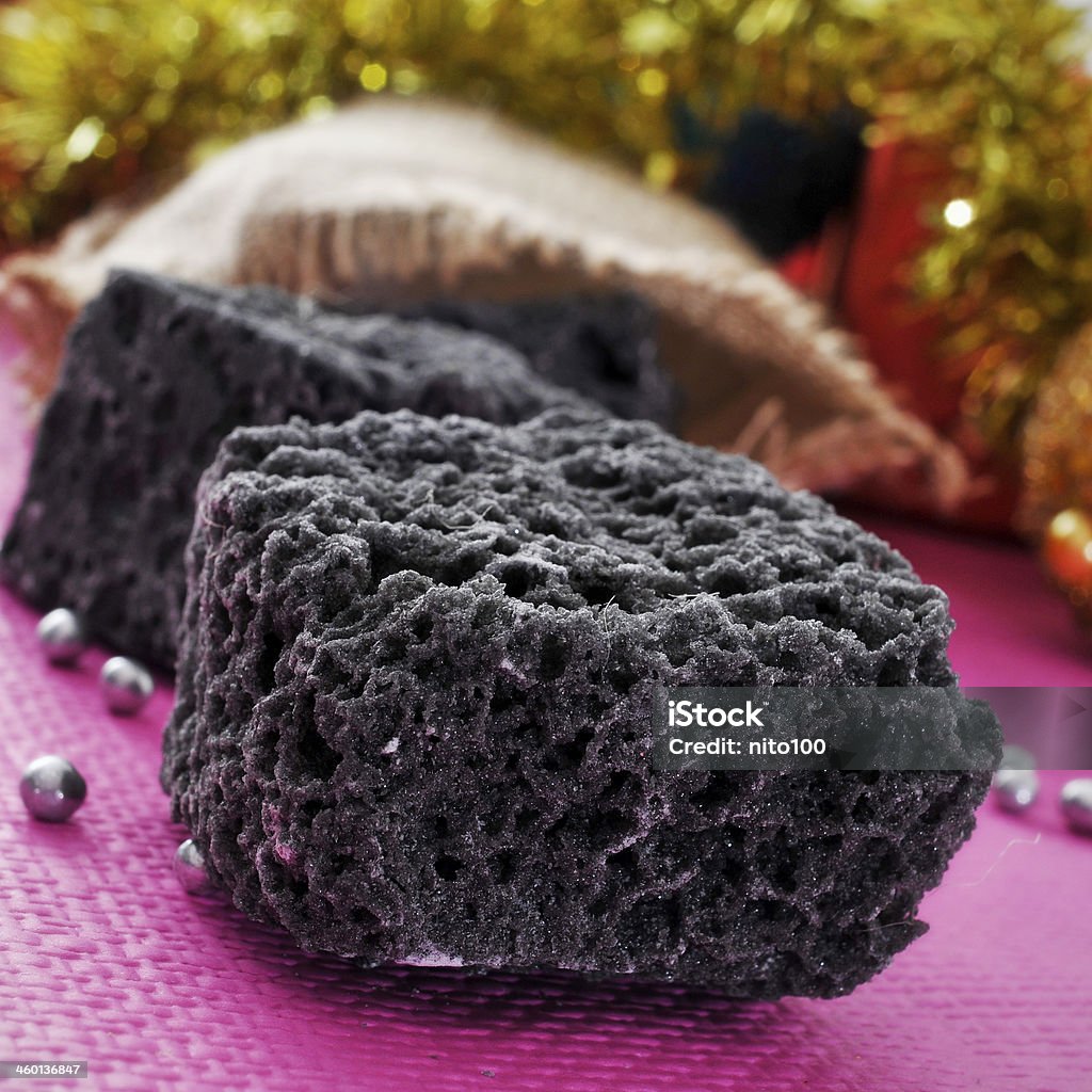 christmas candy coal some lumps of candy coal and some christmas ornaments Bumpy Stock Photo