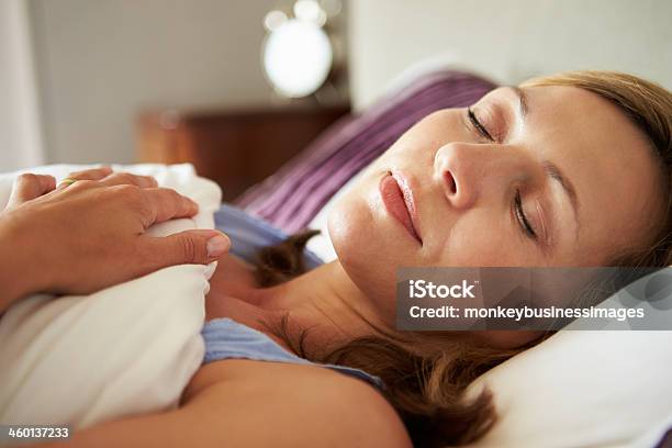 Attractive Middle Aged Woman Asleep In Bed Stock Photo - Download Image Now - Sleeping, Women, One Woman Only