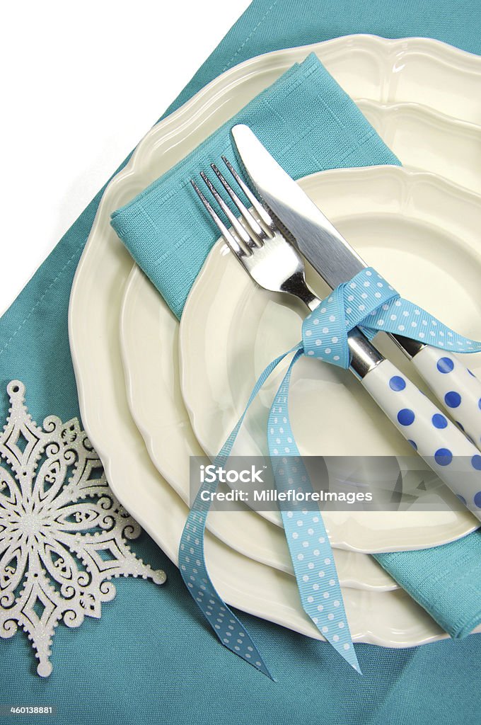 Beautiful aqua blue festive Christmas dining table place setting Beautiful aqua blue festive Christmas dining table place setting with Happy Holiday ornaments and decorations with copy space for your text here. Blue Stock Photo