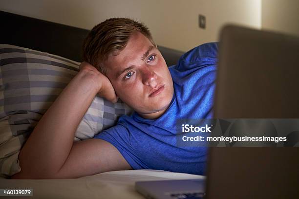 Teenage Boy Using Laptop In Bed At Night Stock Photo - Download Image Now - Laptop, Teenager, Dark