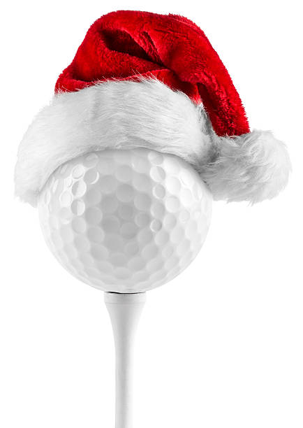 golf ball on tee santa hat stock photo