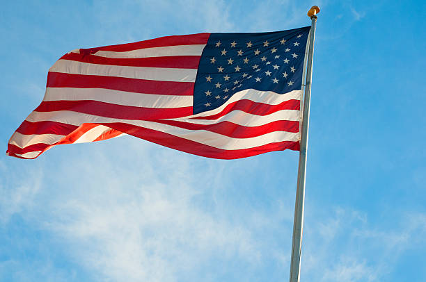 istock Waving American Flag in a blue sky 460140167
