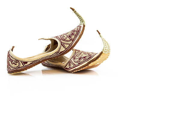 Handmade leather slippers from Dubai Red handmade slippers from Dubai, isolated on white. handmade indian shoes on white stock pictures, royalty-free photos & images