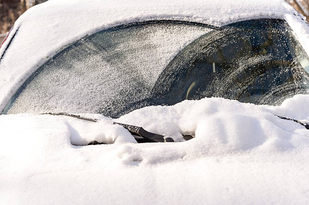 Snow on windshielf of car stock photo