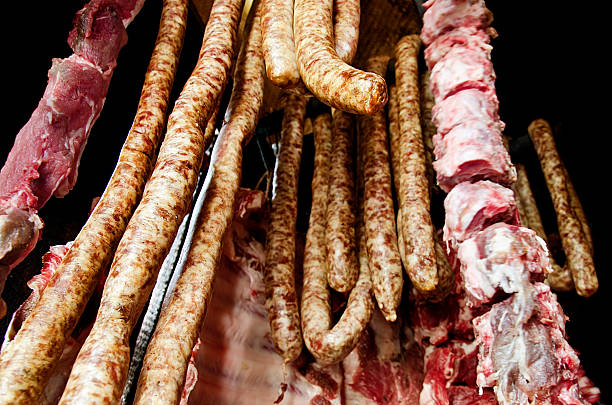 istock fresh pork and sausages hanged for smoking 460141655